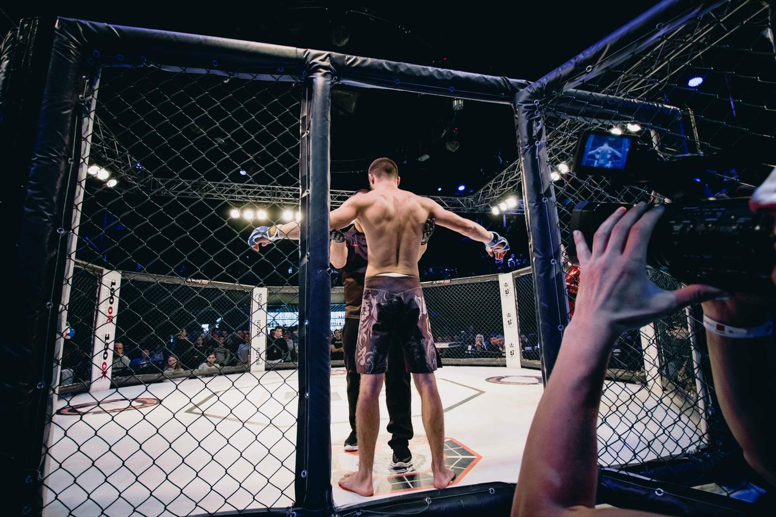 A fighter stands at the entrance of the RFP cage before a bout.