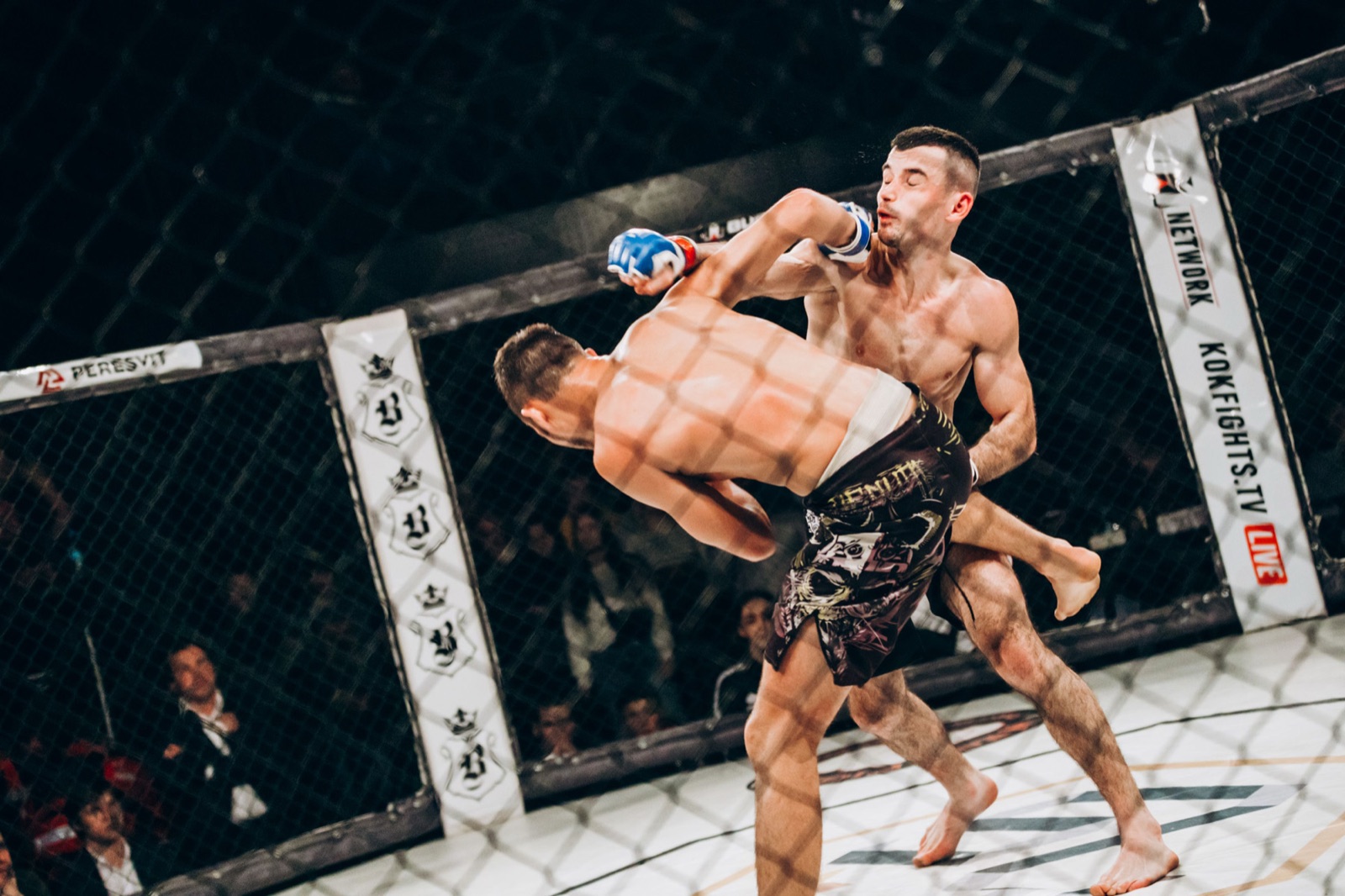Two MMA fighters in a dynamic exchange inside the RFP cage.